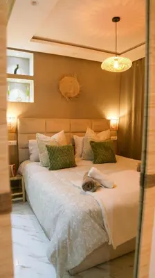 a dog laying on a bed in a bedroom at Victor Hugo Prestige Suite in Marrakech
