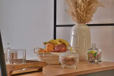 a table with a basket of fruit and a vase at Studio luxueux - centre ville in Marrakech