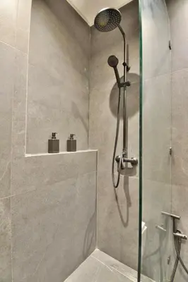 a shower with a glass door in a bathroom at Studio luxueux - centre ville in Marrakech