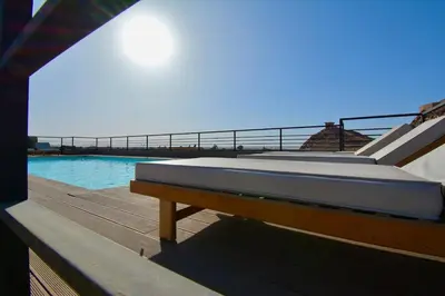 a swimming pool with a mattress on top of a house at Studio luxueux - centre ville in Marrakech