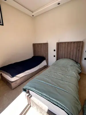 a bedroom with two beds in a room at Villa l'odyssée in Marrakech