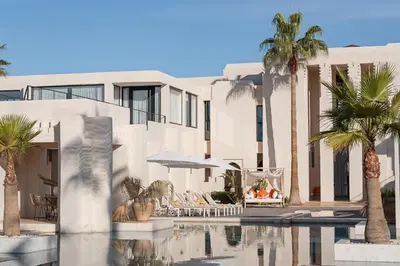 a hotel with palm trees and a swimming pool at Villa Montbel in Marrakech