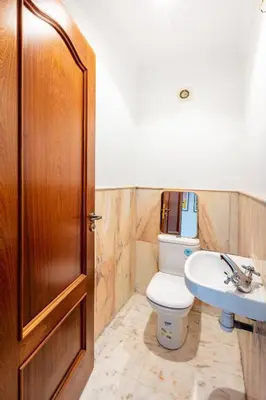 a bathroom with a toilet and a sink at Perle Soft light and air conditioning in Marrakech