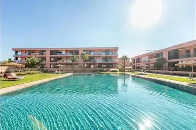 a large swimming pool in front of a building at Marrakech Peaceful Escape - Appartement Noria Marrakech in Marrakech