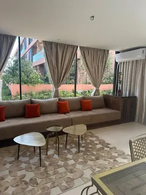 a living room with a couch and two tables at Marrakech Peaceful Escape - Appartement Noria Marrakech in Marrakech