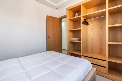 a bedroom with wooden shelves and a bed at Villa Djenna piscine privée sans vis-à-vis in Marrakech