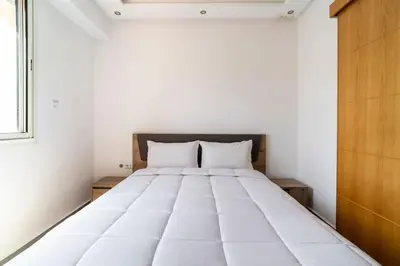 a large white bed in a room with a window at Villa Djenna piscine privée sans vis-à-vis in Marrakech