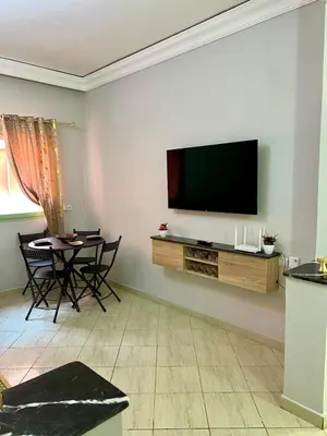 a living room with a flat screen tv on a wall at Appartement allal el fassi in Marrakech