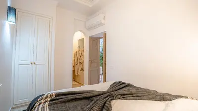 a bedroom with a bed with a blanket on it at Riad Lalla Sofia à 200m des tombeaux Saadiens in Marrakech