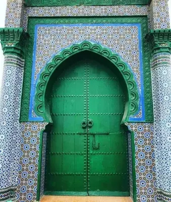 a green door on the side of a building at Riad El yacout in Marrakech