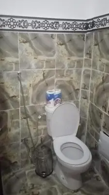 a bathroom with a toilet in a stone wall at Riad El yacout in Marrakech