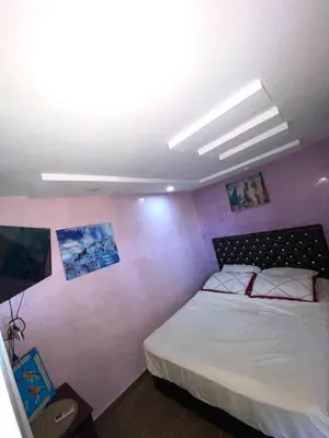 a bedroom with a bed with a purple wall at Dar Hiba in Marrakech