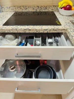 a kitchen drawer filled with pots and pans at VIVASTAY Marrakech - Prestigia Topaze- Terrace overlooking garden & pool in Marrakech