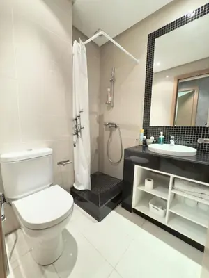 a bathroom with a toilet and a sink and a shower at VIVASTAY Marrakech - Prestigia Topaze- Terrace overlooking garden & pool in Marrakech