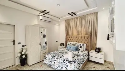 a bedroom with a large bed with blue pillows at Villa à marrakech in Marrakech