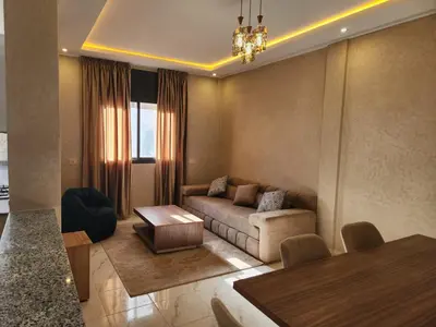 a living room with a couch and a table at Appartement Aéroport Holiday in Marrakech