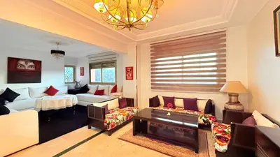 a living room with couches and a chandelier at HiverLux in Marrakech