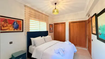 a bedroom with a bed with towels on it at HiverLux in Marrakech