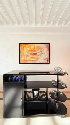 a room with a table and a painting on the wall at HiverLux in Marrakech