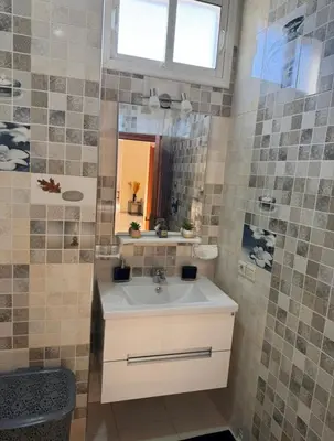 a bathroom with a sink and a mirror at Maison luxueuse méga spacieuse in Marrakech