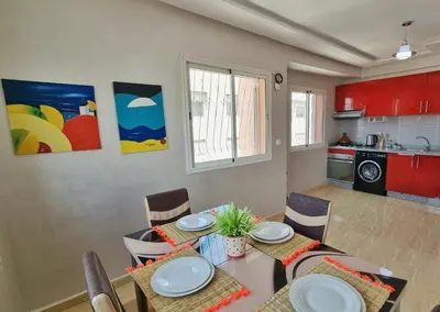 a kitchen and dining room with a table and chairs at Ilova 1 - Appartement Moderne au Centre de Marrakech in Marrakech