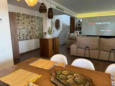 a living room with a table and a couch at Exceptional duplex apartment in Guéliz with Jacuzzi in Marrakech