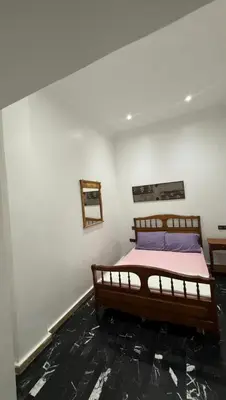 a bedroom with a bed in a white wall at Appartement au centre de Marrakech in Marrakech