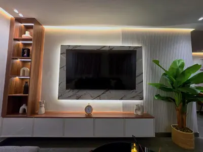 a living room with a television on a wall at Central New 1BR Next to the Train Station in Marrakech