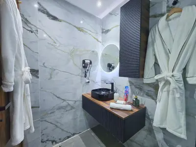 a bathroom with a sink and a mirror at Central New 1BR Next to the Train Station in Marrakech