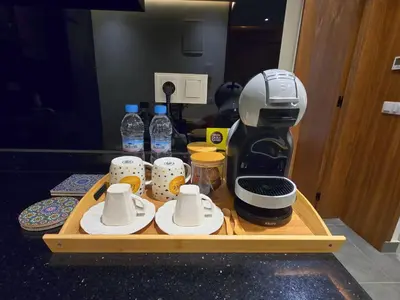 a coffee maker and cups on a wooden tray at Central New 1BR Next to the Train Station in Marrakech