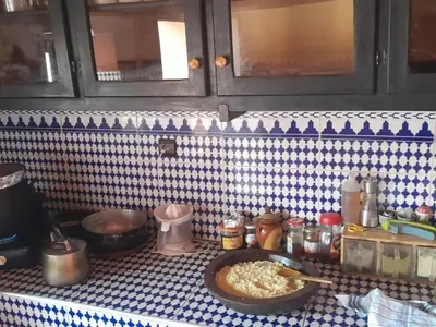 a kitchen counter with a bowl of food on a table at Chants des dunes in Marrakech