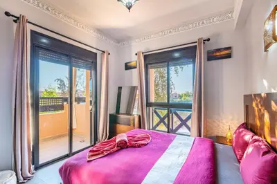 a bedroom with a bed and a large window at Nid Andalou balcony and calm in Oulad Akkou
