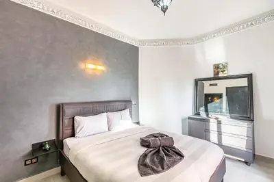 a bedroom with a bed with a towel on it at Nid Andalou balcony and calm in Oulad Akkou