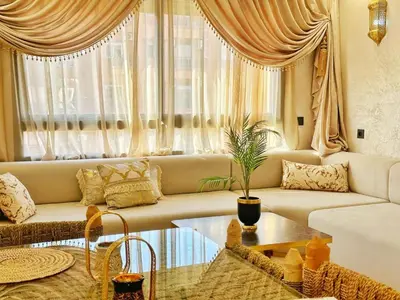 a living room with a couch and a table at Appartement Marrakech-GOLDEN OASIS in Marrakech