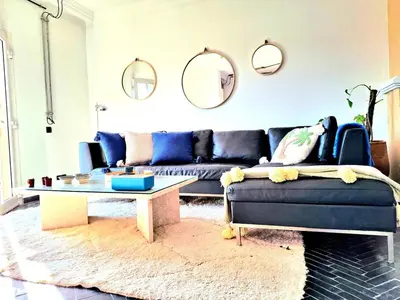 a living room with a blue couch and a coffee table at Central Atlas View in Marrakech