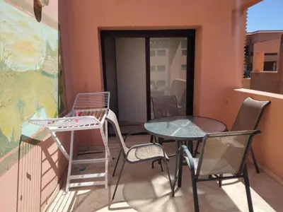a balcony with chairs and a table and chairs at Babylon 1
