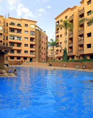 a large pool of blue water in front of buildings at Babylon 1