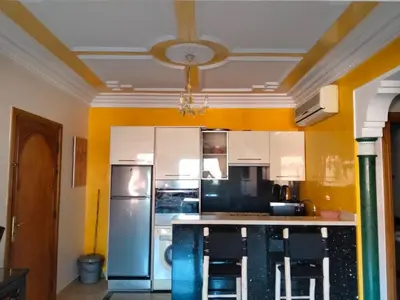 a kitchen with a refrigerator and a ceiling at Babylon 1