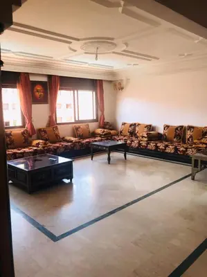 a large living room with couches and tables at Babylon 1