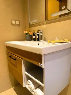 a bathroom with a white sink and a mirror at Appartement Chic 2 Chambres Centre Marrakech près de la Gare in Marrakech