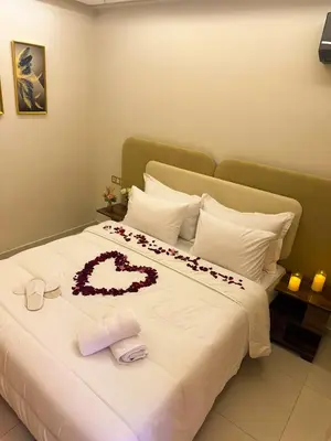 a bed with a heart made out of roses on it at Appartement Chic 2 Chambres Centre Marrakech près de la Gare in Marrakech