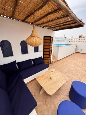 a living room with a blue couch and a table at Riad Keke 4 suites - Pool&Rooftop - Bahia in Marrakech