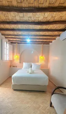 a bedroom with a large white bed with two lights at Riad Keke 4 suites - Pool&Rooftop - Bahia in Marrakech