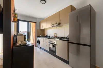 a kitchen with a stainless steel refrigerator and appliances at Atlas Luxury Escape Golf Noria Pool & Quiet in Marrakech