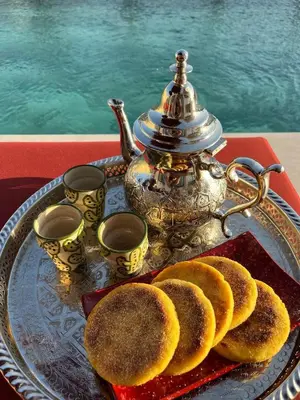 a tray with a tea kettle and biscuits on a table at Villa Marraktus Marrakech in Marrakech