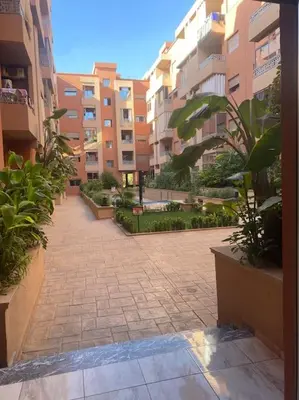 a courtyard in a building with plants and buildings at Appartement de luxe avec piscine in Marrakech