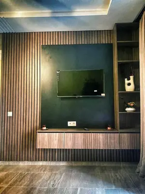 a living room with a flat screen tv on a wall at Appartement de luxe avec piscine in Marrakech