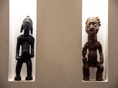 two wooden figurines on display on a wall at Riad Jebly - Exclusive -Jacuzzi & Breakfast ,10 min walk Jemaa El Fnaa - Panoramic View Rooftop in Marrakech