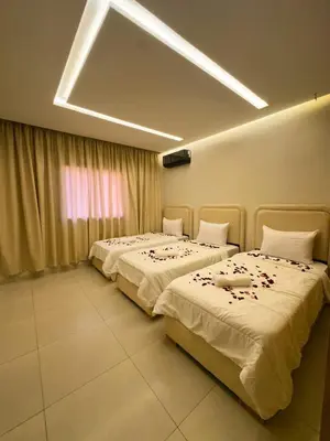 a room with two beds with flowers on them at Stylish 2-bed flat in Marrakech city center - steps from train station in Marrakech