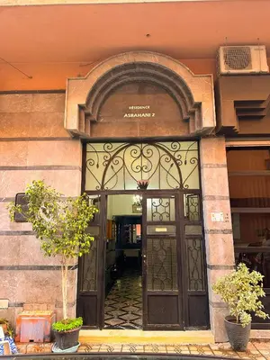 an entrance to a building with a large door at Stylish 2-bed flat in Marrakech city center - steps from train station in Marrakech